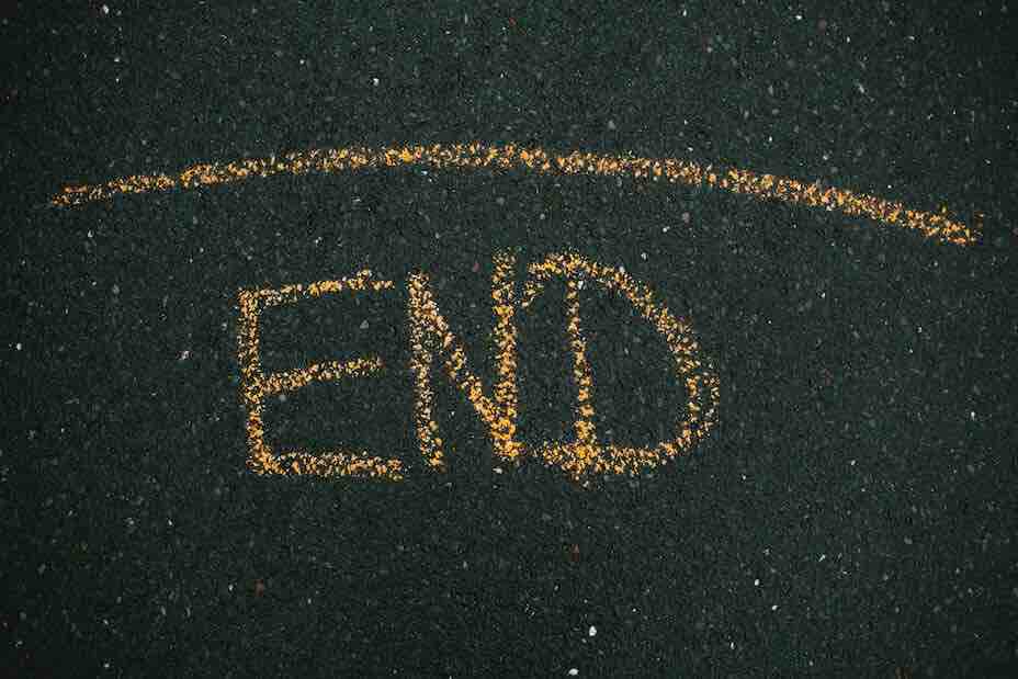 The word "end" written in chalk on blacktop