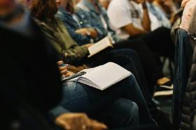 Group of people with open notebooks on lap