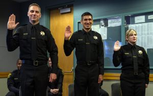 three correction officers taking an oath