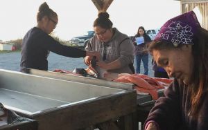 people cleaning salmon