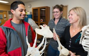 Female teacher with whale bones with male and female students