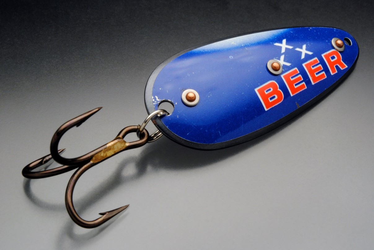 Recycled handmade lure that reads "beer"