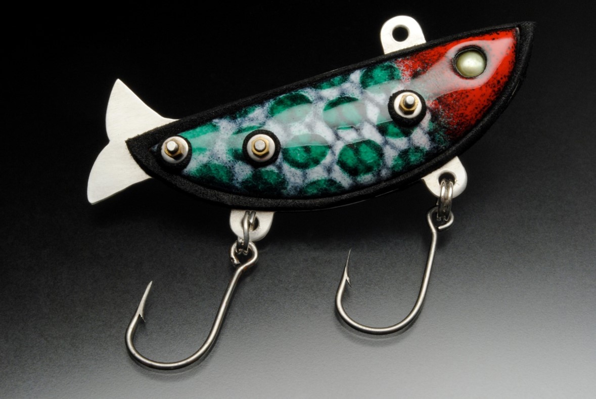 Handmade lure made to look like a green and red fish