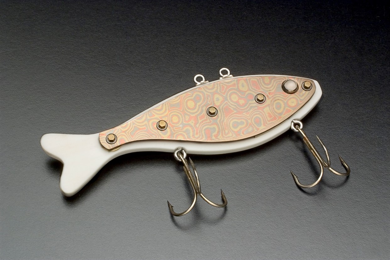 Handmade lure made to look like a white and gold fish